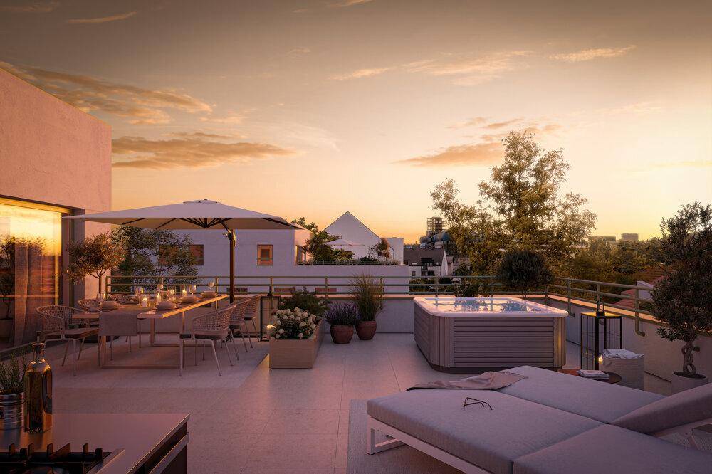 Stimmungsvolle Dachterrasse bei Sonnenuntergang mit Whirlpool, Essbereich und Außenküche.