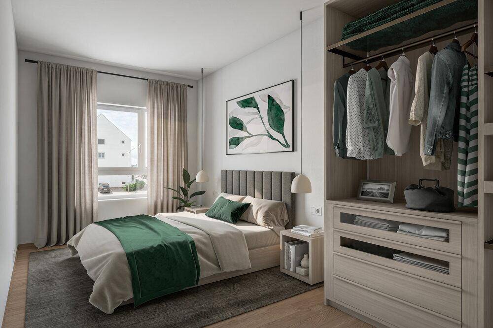 Modernes Schlafzimmer mit Holzboden, Einbauschrank und grünen Akzenten, gut beleuchtet.