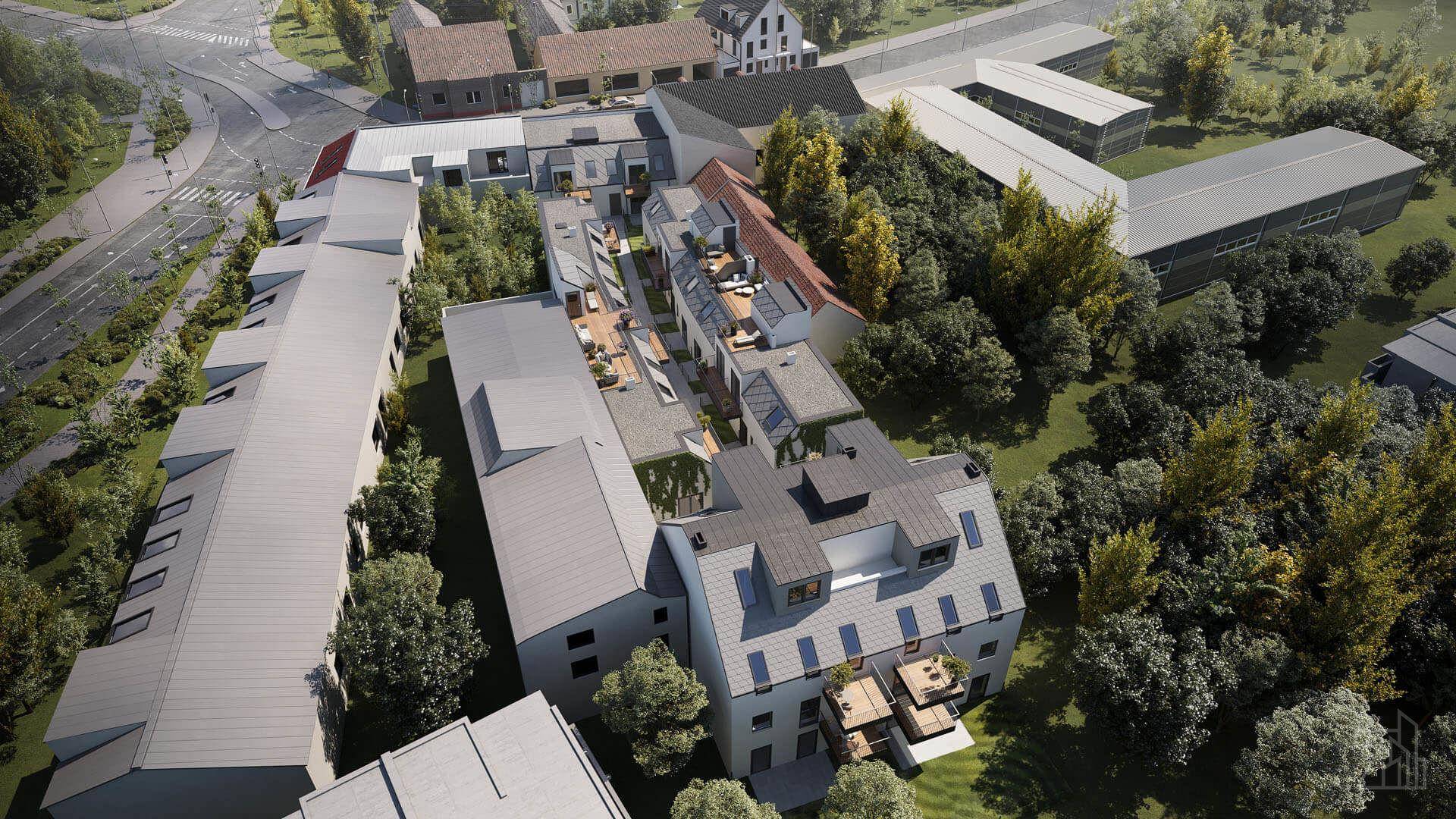 Weitläufige Luftaufnahme einer modernen Wohnsiedlung mit viel Grün und Flachdächern.