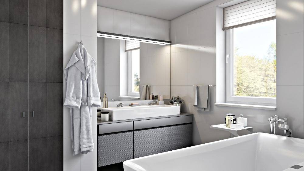 Modernes Badezimmer mit Badewanne, großem Spiegel und Fenster für Tageslicht.