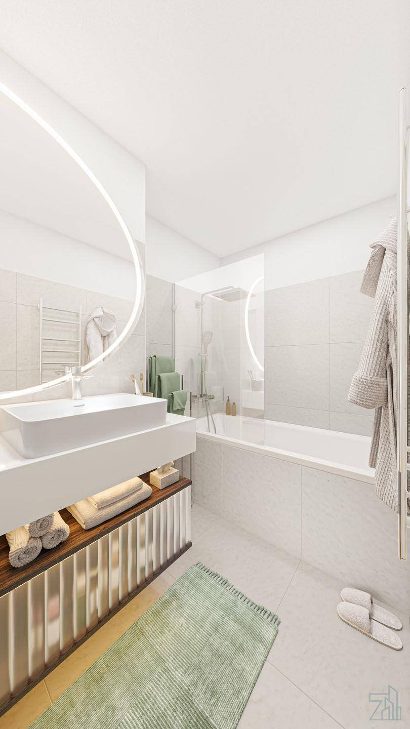 Modernes Badezimmer mit Badewanne, Waschtisch und beleuchtetem Spiegel.