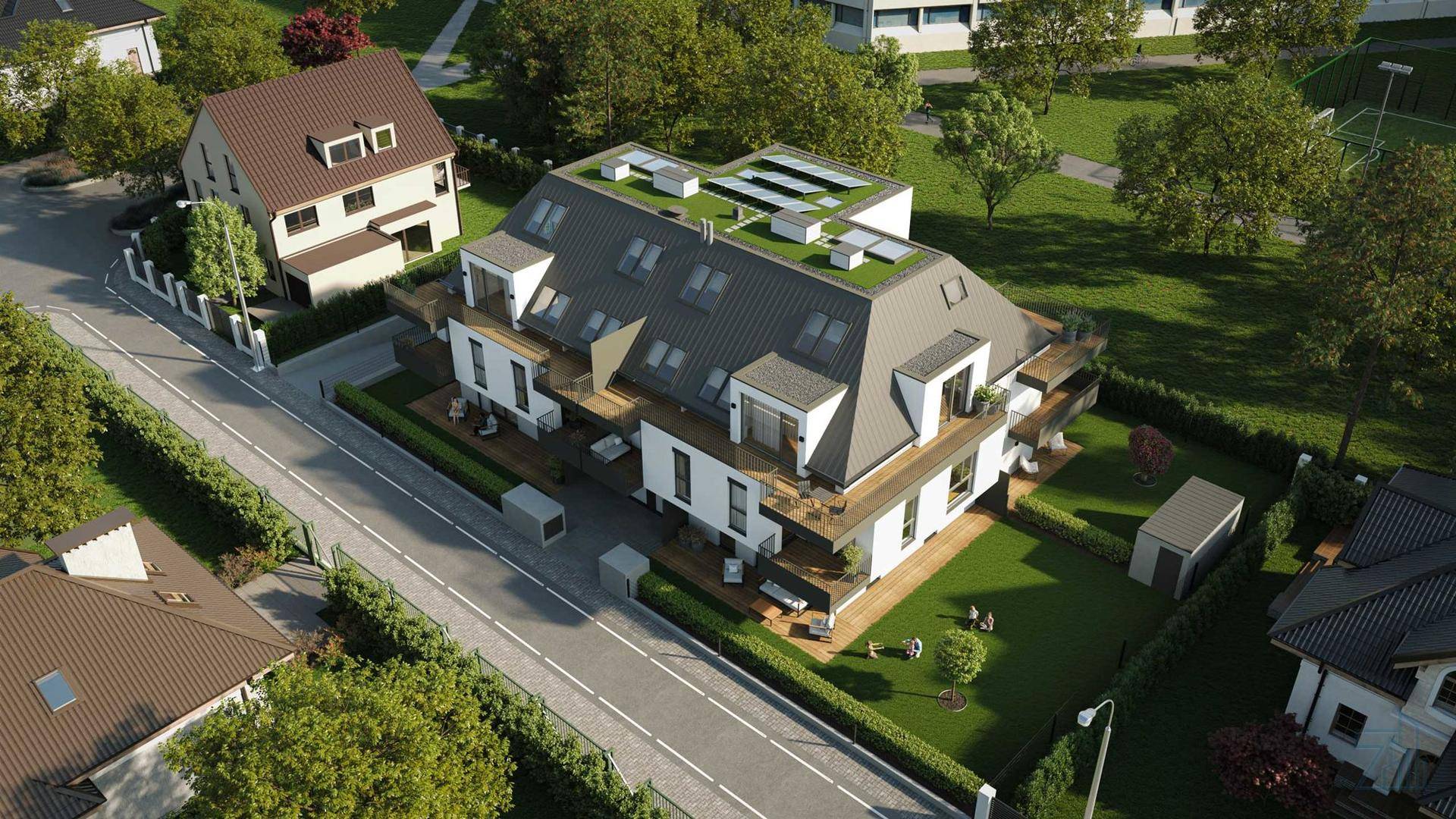 Vogelperspektive einer modernen Wohnanlage mit Gründächern und Photovoltaikanlage.