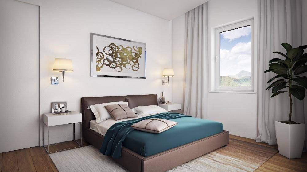 Gemütliches Schlafzimmer mit Doppelbett, Holzboden und Fenster mit Blick ins Grüne.