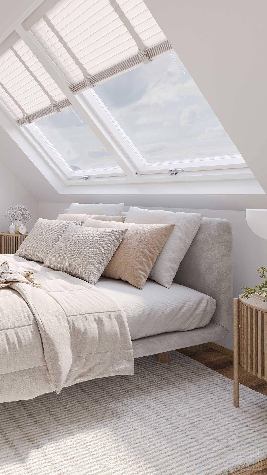 Helles Schlafzimmer im Dachgeschoss mit großen Dachfenstern, schräger Decke und modernem Design.