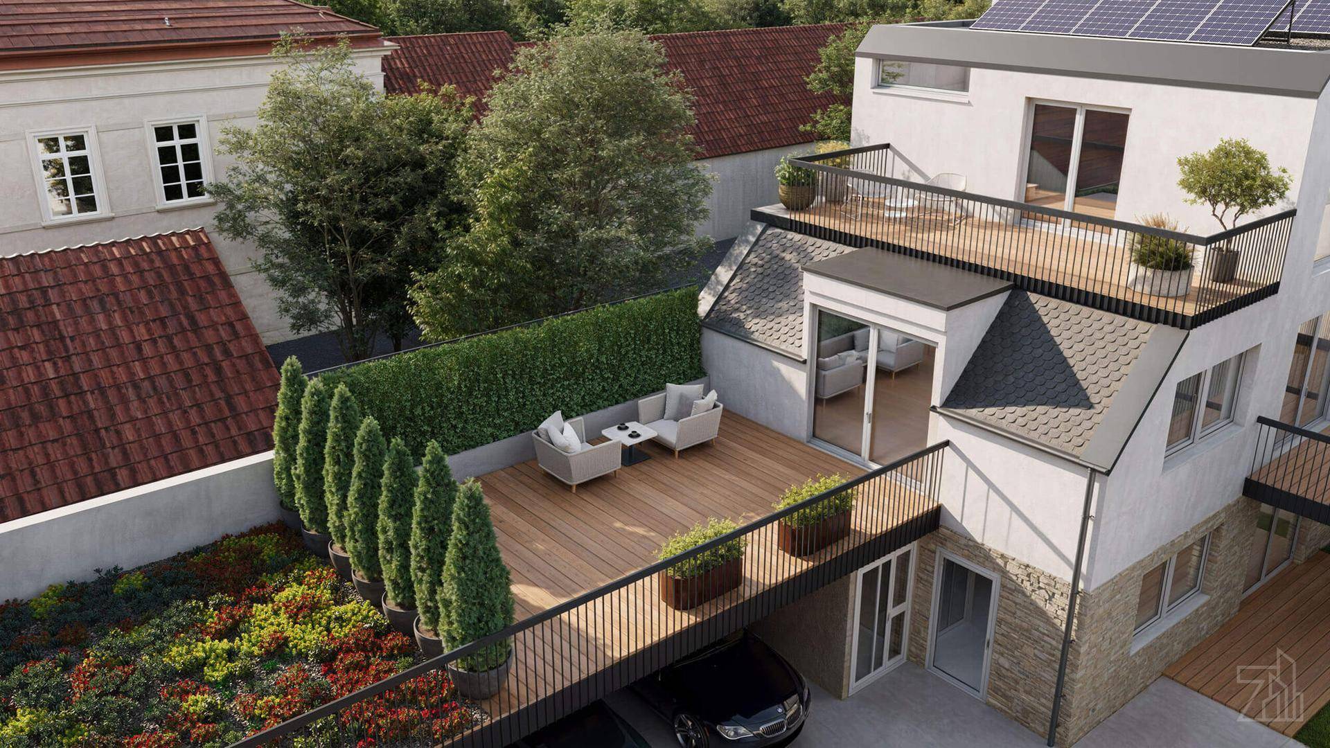 Dachaufsicht auf das moderne Gebäude mit mehreren Terrassen, einem Garten und Photovoltaikanlage auf dem Dach.