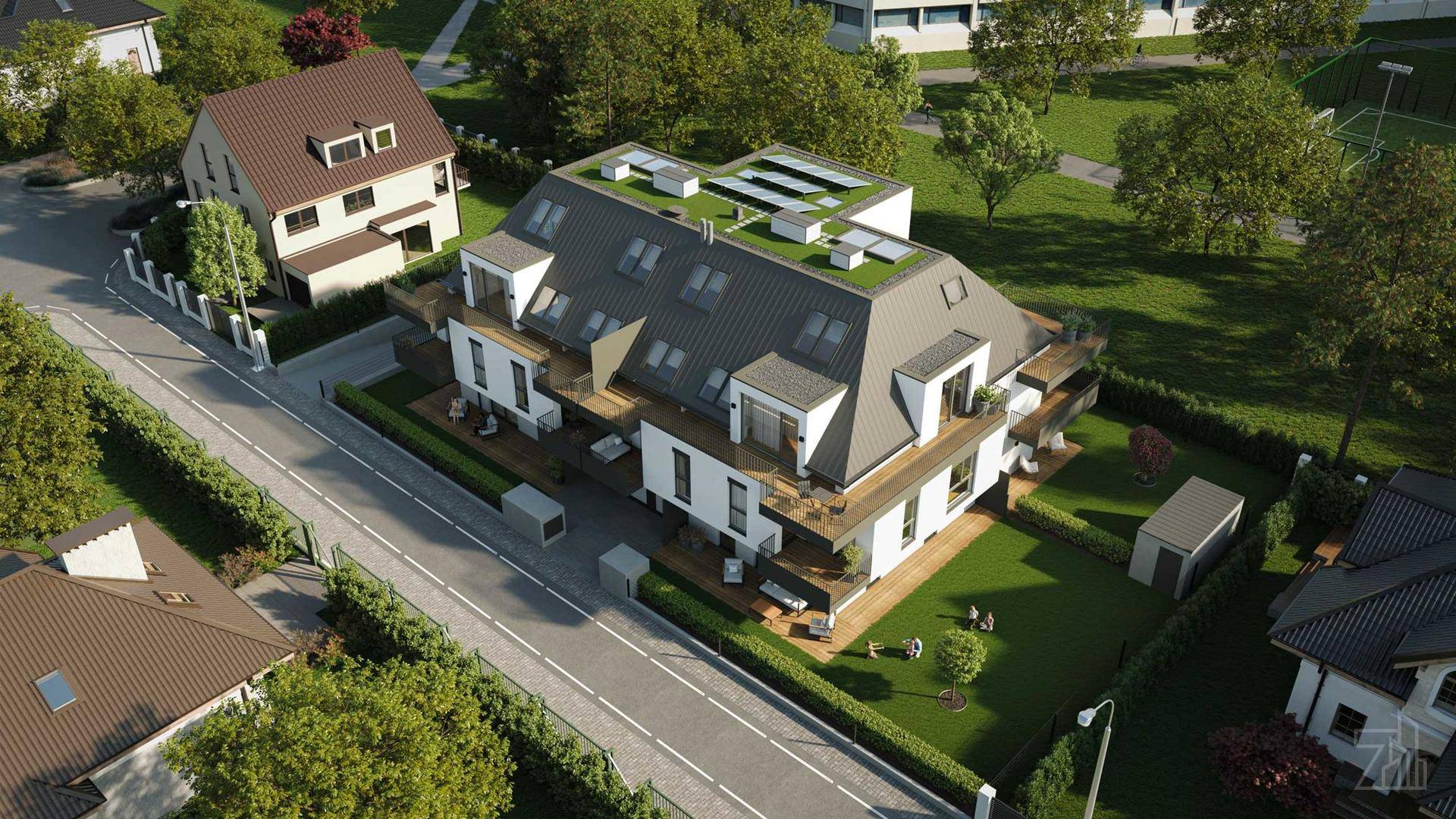 Luftaufnahme der modernen Wohnanlage mit umliegenden Gärten, Straßen und Solaranlage auf dem Dach.