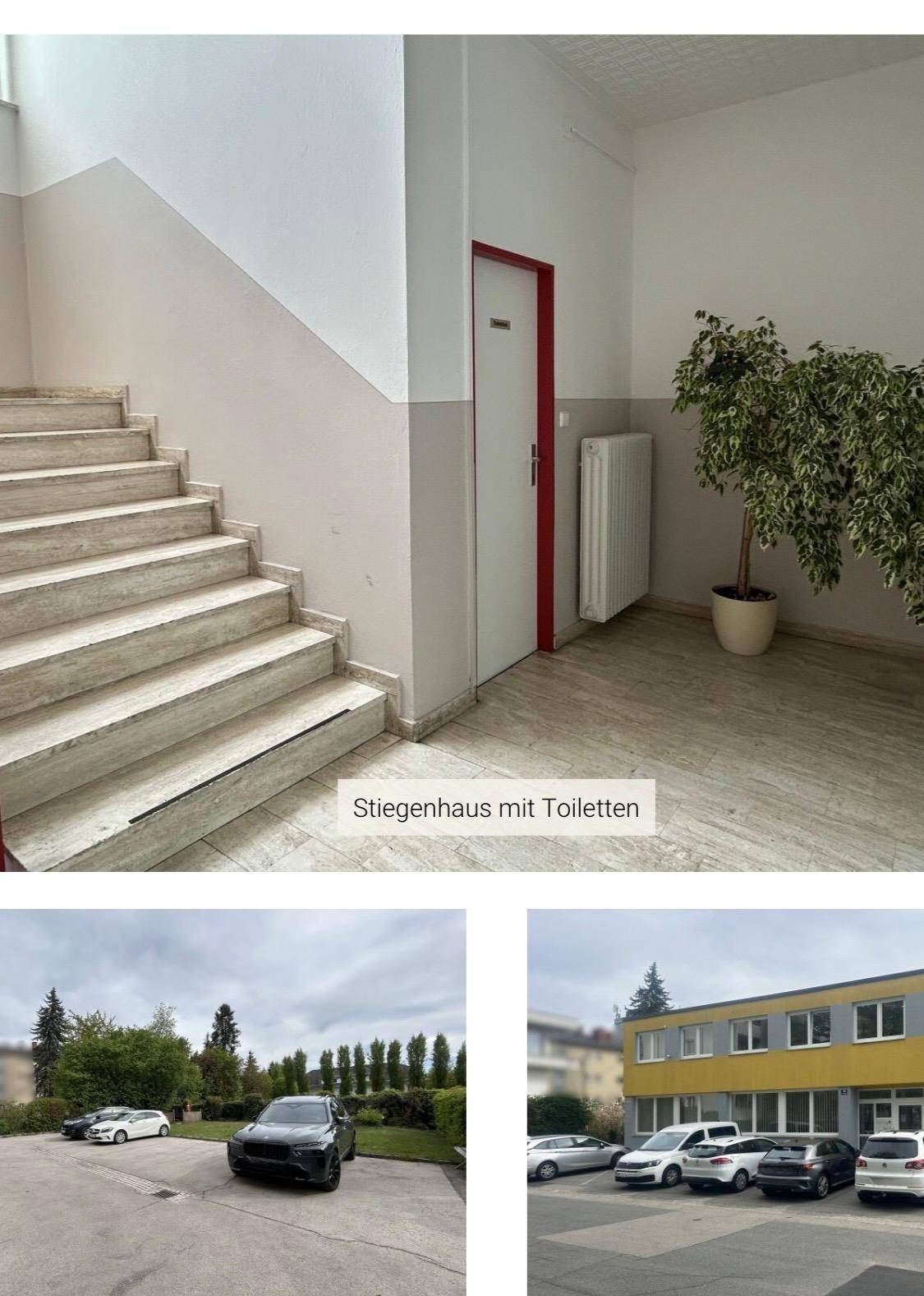 Helles Treppenhaus mit Fliesenboden, roter Tür und Blick auf den Außenbereich mit Parkplätzen.