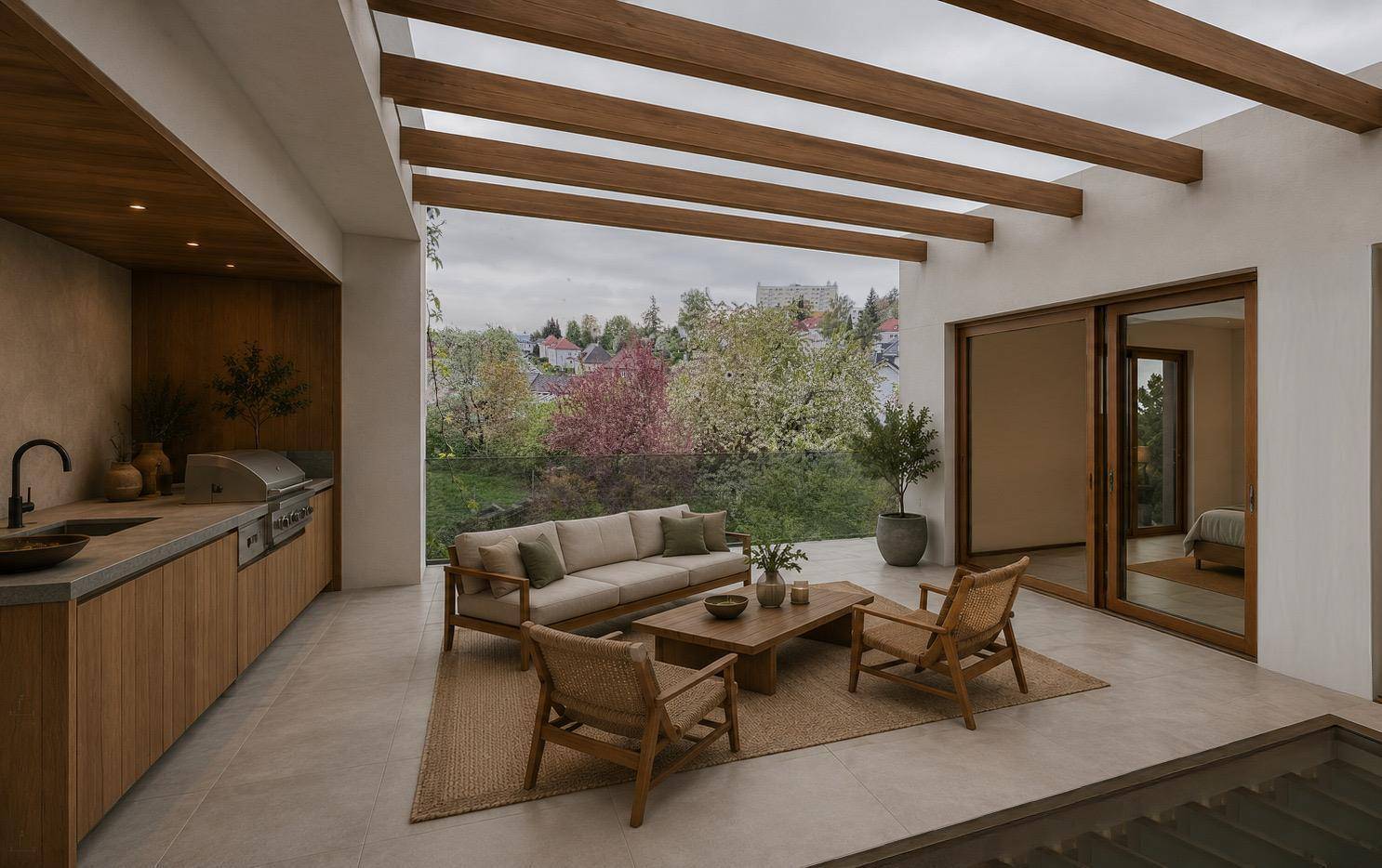 Geräumige Terrasse mit moderner Outdoor-Küche, bequemen Sitzmöbeln und Blick ins Grüne.