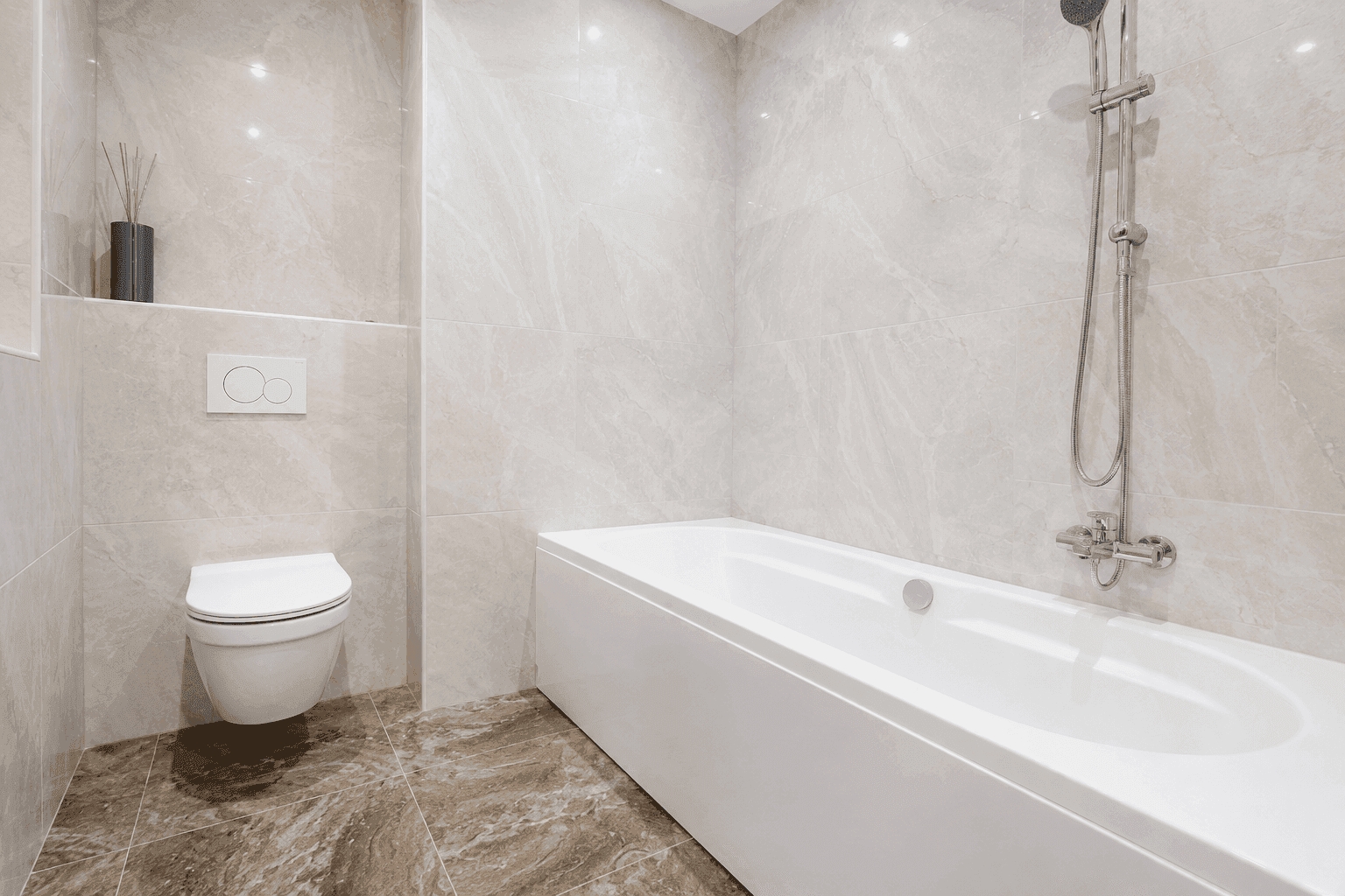 Modernes Badezimmer mit Badewanne, wandhängendem WC und beigefarbenen Marmorfliesen.