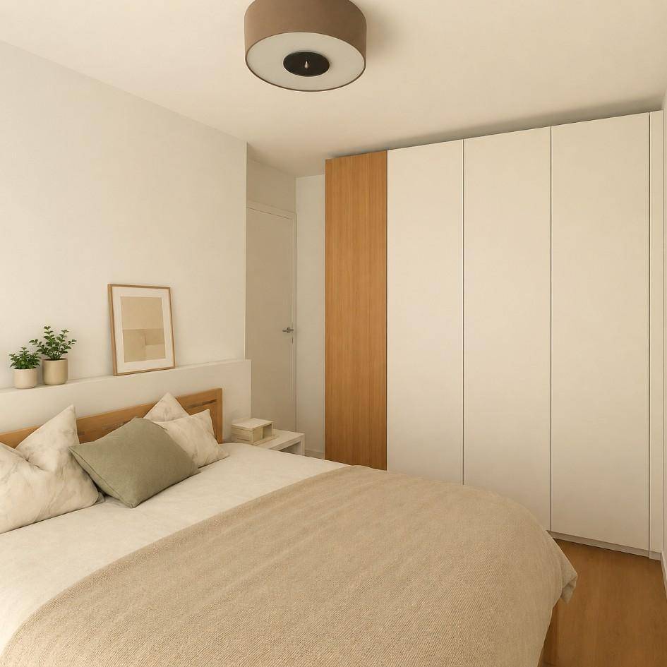 Gemütliches Schlafzimmer mit Doppelbett, integriertem Kleiderschrank und heller, moderner Einrichtung.