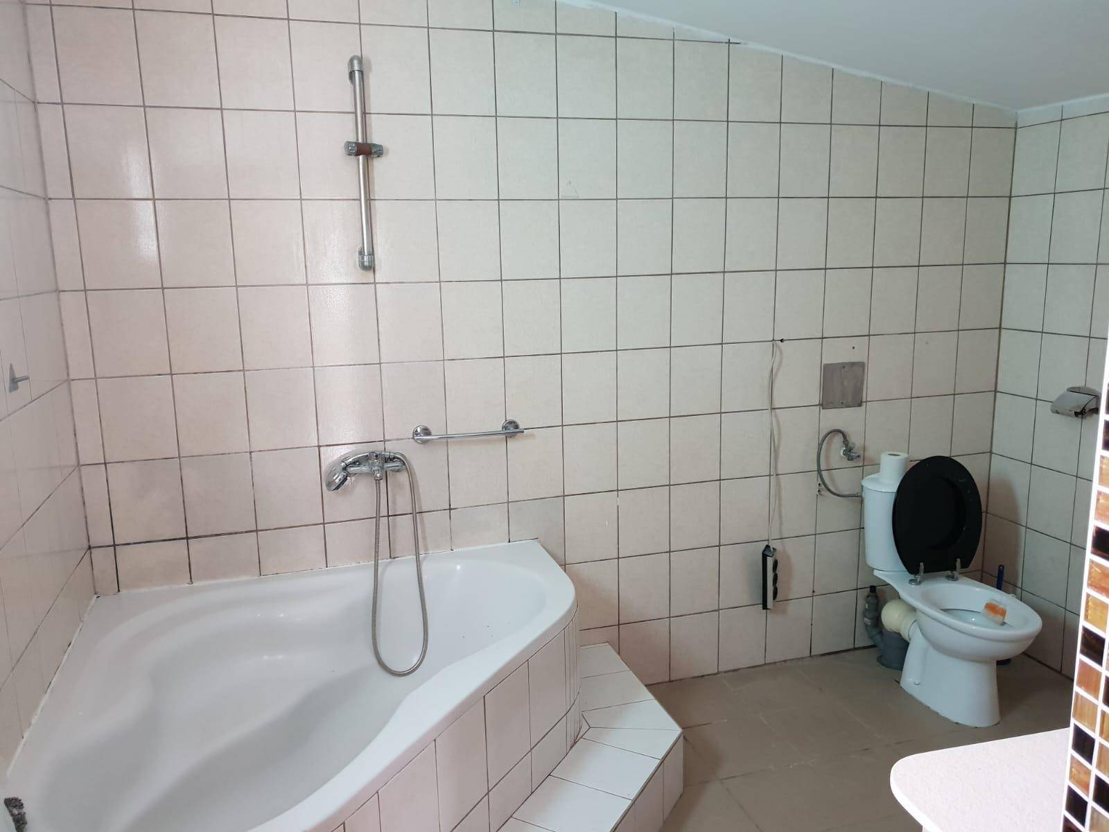 Geräumiges Badezimmer mit Eckbadewanne, Dusche, Toilette und Bidet.