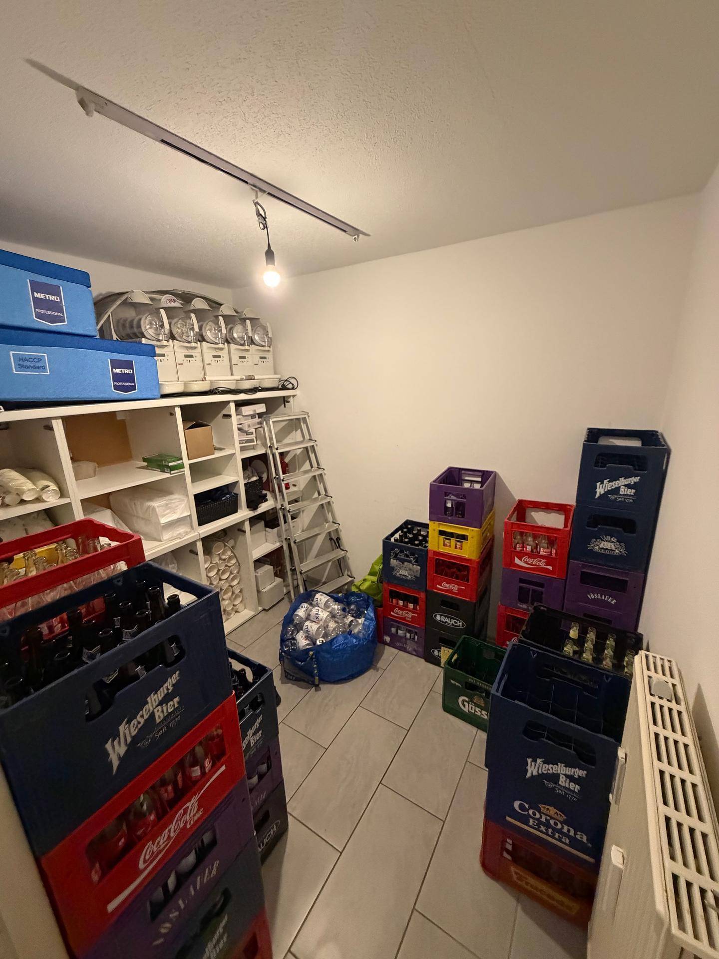 Lagerraum gefüllt mit Getränkekisten und Regalen, ideal für gewerbliche Nutzung.