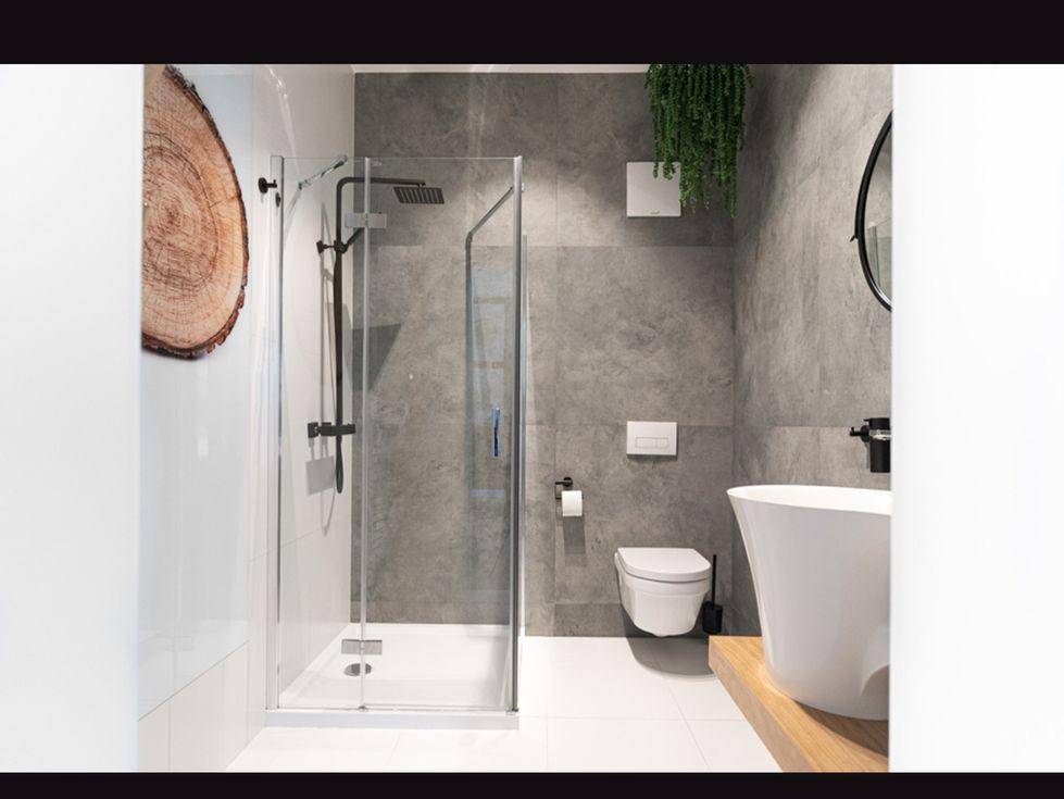 Modernes Badezimmer mit grauen Fliesen, begehbarer Dusche und minimalistischem Design.