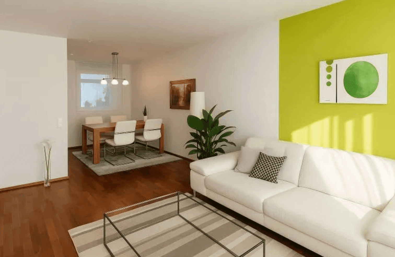 Offener Wohn- und Essbereich mit hellem Sofa, Esstisch und einer lebhaften grünen Akzentwand.