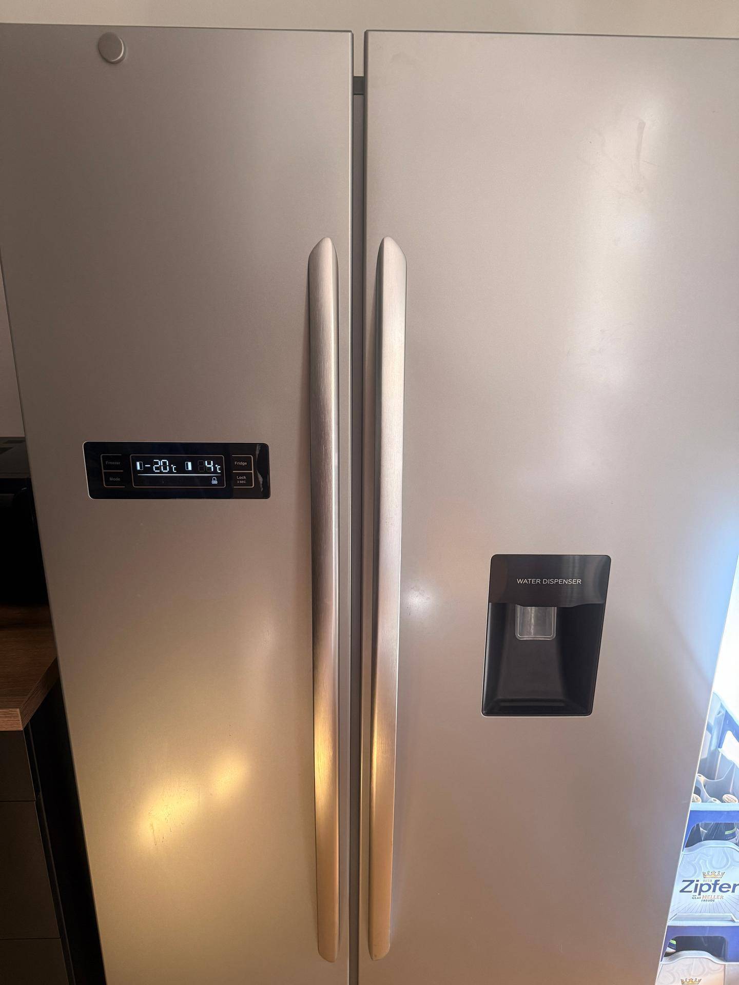 Moderner Side-by-Side Kühlschrank mit Wassertank und digitaler Temperaturanzeige.