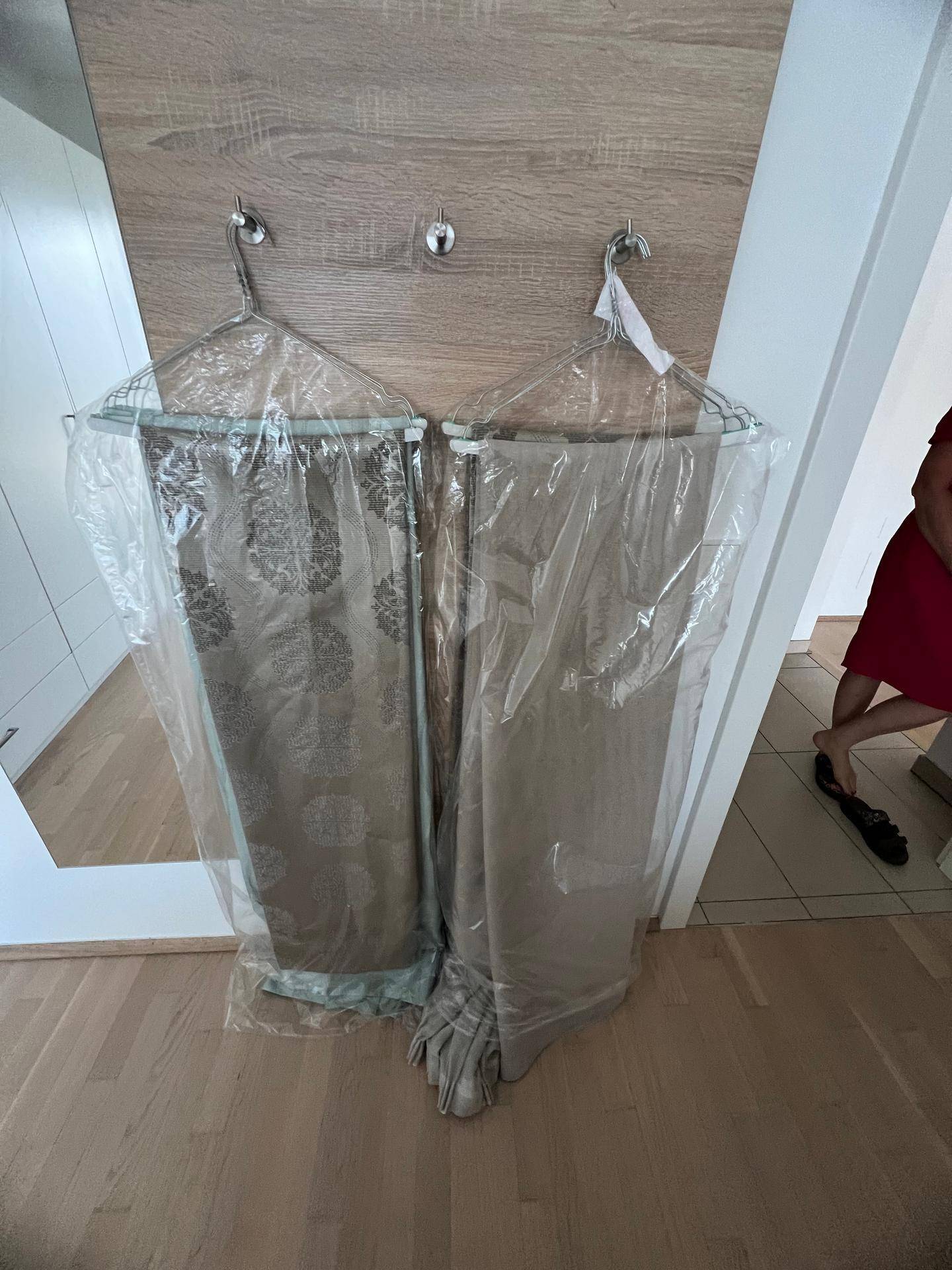 Vorhänge in Schutzfolie, bereit zur Installation in einem Innenraum.