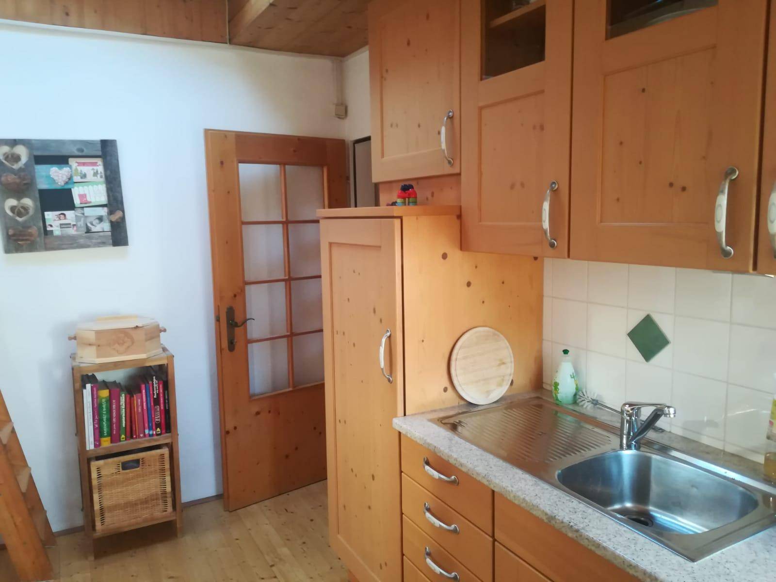 Traditionelle Holzküche mit Einbauschränken, Spüle und rustikalem Charme.