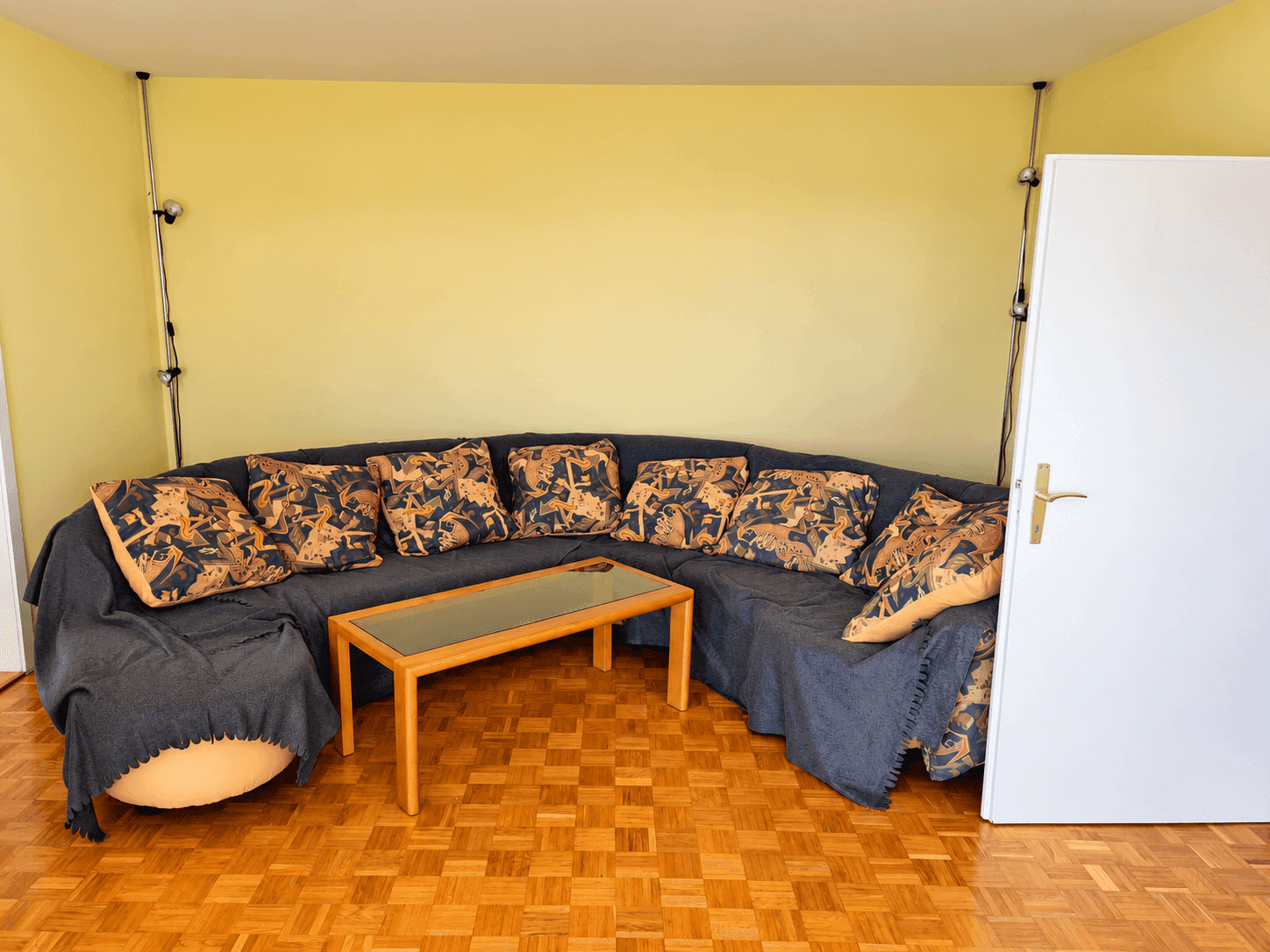 Gemütliches Wohnzimmer mit großem Ecksofa, Couchtisch und hellem Parkettboden.