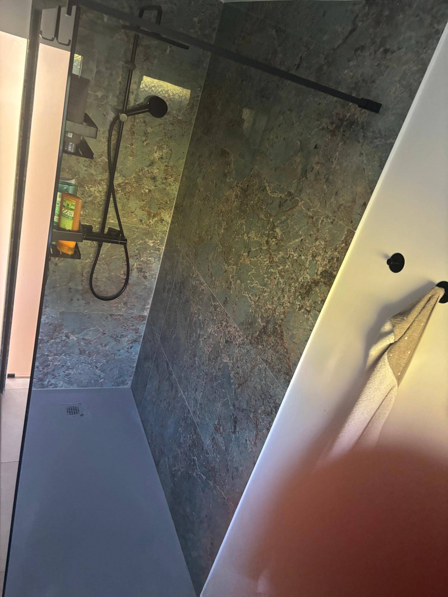 Geräumige begehbare Dusche mit modernen Fliesen und Glasabtrennung.