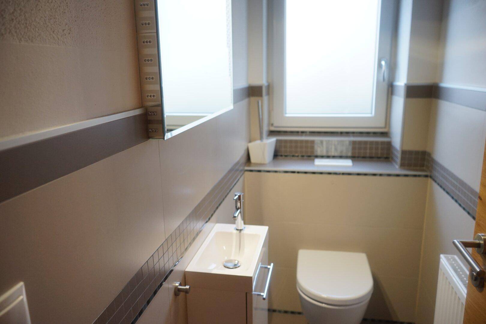 Separates WC mit Waschbecken und Fenster
